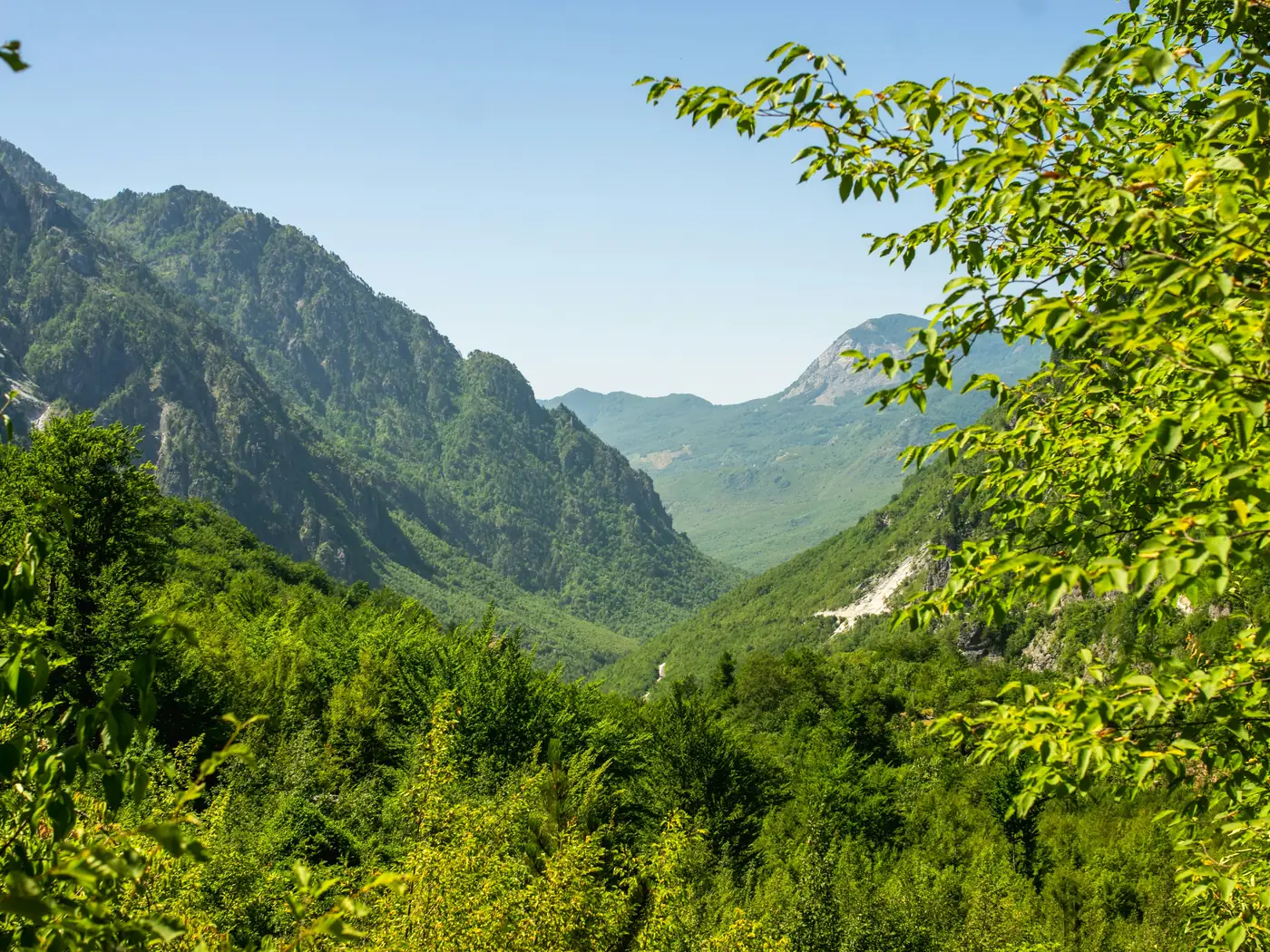 Guesthouse and stone church in the Theth valley below the Albanian Alps